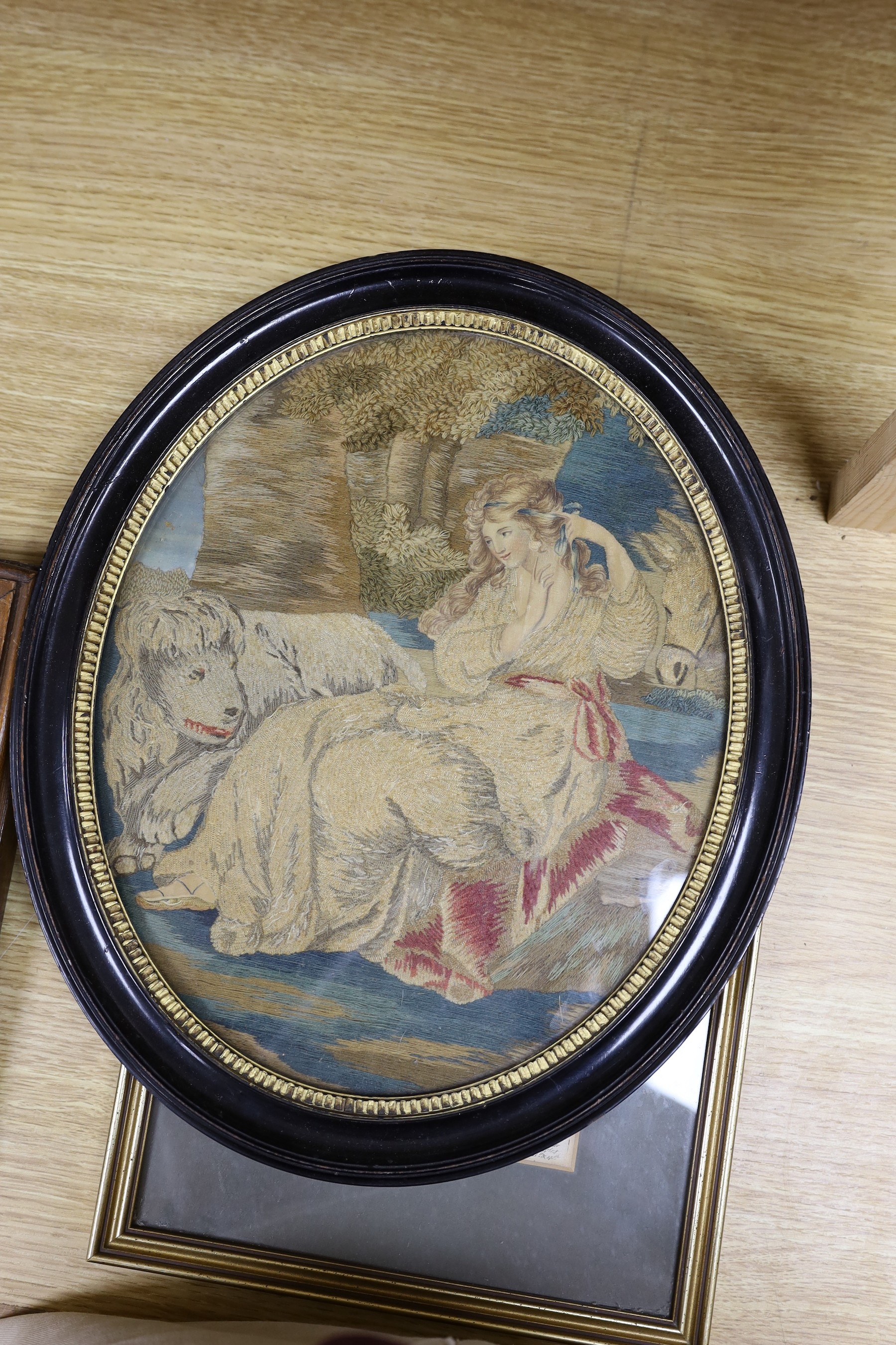 Three late 19th / early 20th century framed tapestries - a mountain scape with farmer and heard, a female figure with animal, and a with lions and men on horseback fighting scene, together with two maps - ‘Gloucestershir